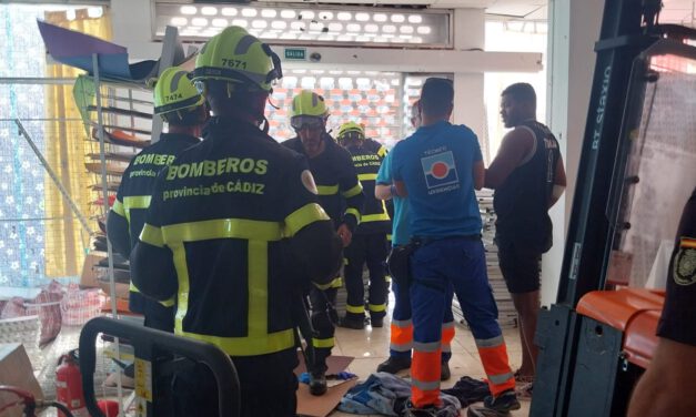 Los bomberos rescatan a una persona atrapada en una máquina elevadora en un local de la avenida de Sanlúcar